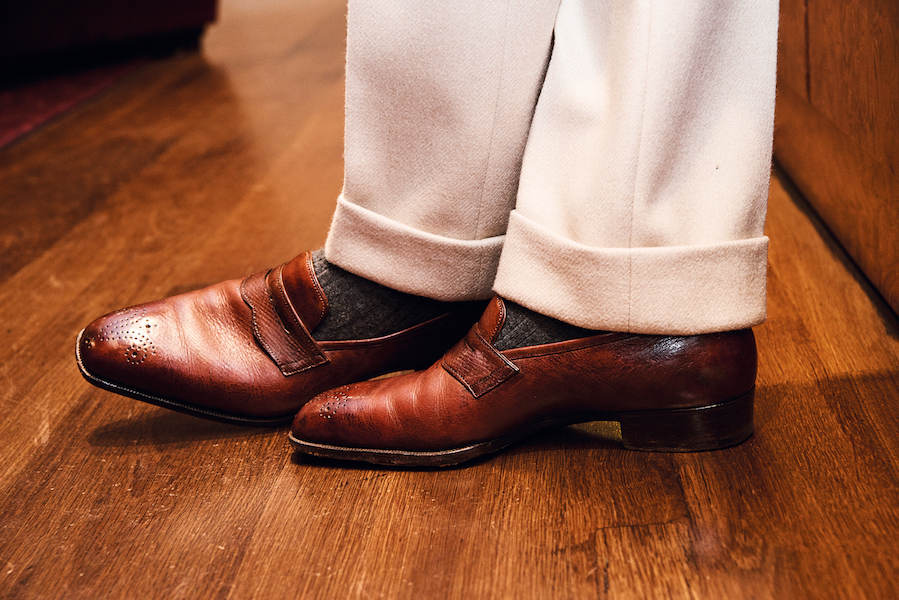 These are one of the finest pairs of shoes I have ever seen: a seamless construction pair of bespoke loafers by Gaziano & Girling made from chestnut hatch-grain calf leather. Perfectly contrasted with his grey William Abraham cotton cashmere socks and striking Elia Caliendo cream trousers made with Holland & Sherry Pardessus heavyweight wool. Everything about this is elegant and inspires envy.