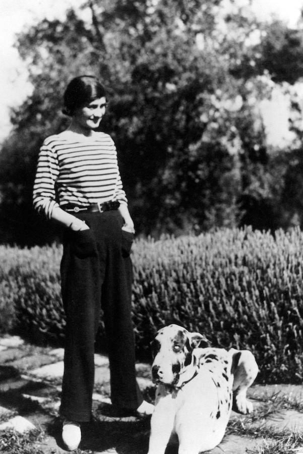 Coco Chanel at her home, Villa La Pausa in Roquebrune, in the French Riviera with her dog, Gigot, circa 1930. Photo by Alamy.