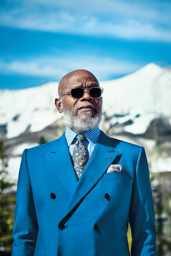 Samuel L Jackson wears Brandeis blue wool-silk double-breasted suit, Dolce & Gabanna; sky blue and white check cotton shirt and silk pocket-handkerchief, both Budd Shirtmakers; Blue and yellow flora silk print tie, Polo Ralph Lauren and vintage mother of pearl boutonniere, both property of The Rake; eyeframes, Barton Perreira, property of Samuel L Jackson in Issue 39 of The Rake. Art and fashion director: Sarah Ann Murray. Photography by Tomo Brejc.