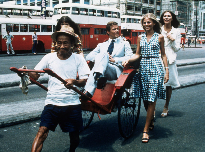 Roger Moore filming Man With The Golden Gun with Maud Adams, Britt Ekland and Guy Hamilton in 1974. Photo by SNAP/REX/Shutterstock.