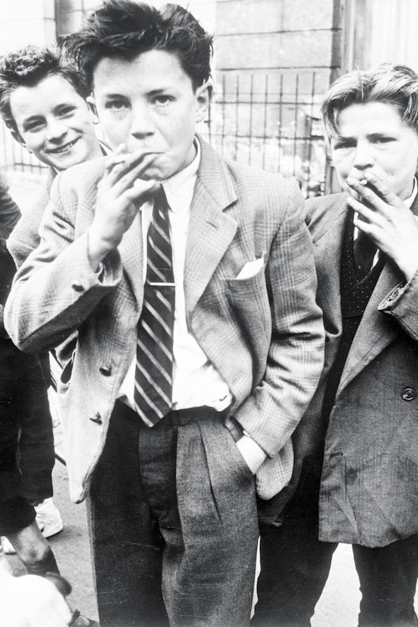 Boys smoking in London, 1956. Photo by Museum of London/Heritage Images/Getty Images.