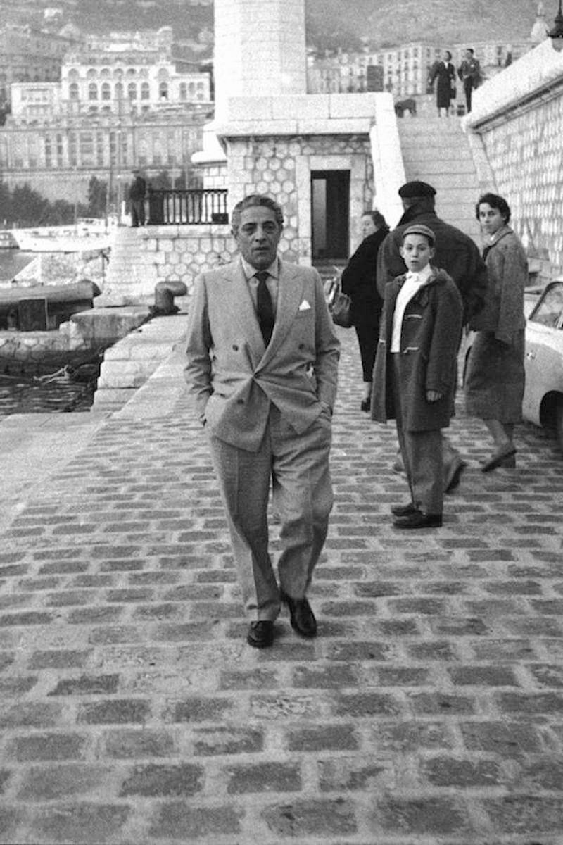 Greek billionaire shipowner Aristotle Onassis strolls along Montecarlo's port, 1961. Photo by Carlo Bavagnoli/Mondadori Portfolio via Getty Images.