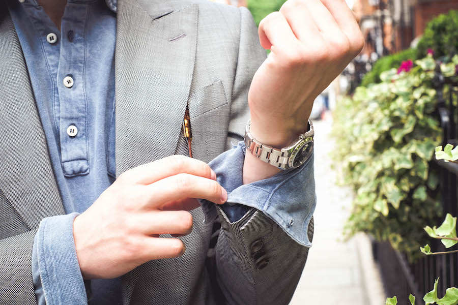 Dark blue long sleeve acid washed pique polo shirt, Naked Clothing; grey suit, Chester Barrie; watch, Rolex property of The Rake.