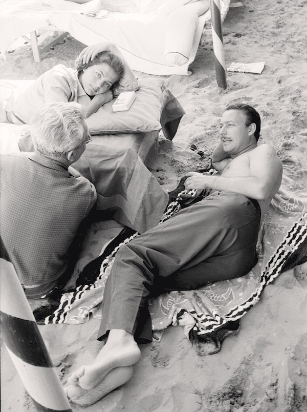 Italian actress Ira von Fuerstenberg and her husband, Spanish prince and entrepreneur Alfonso di Hohenlohe-Langenburg, lying on the beach  during the XVIII Venice International Film Festival. Venice, 1957. Photo by Mario De Biasi via Getty Images.