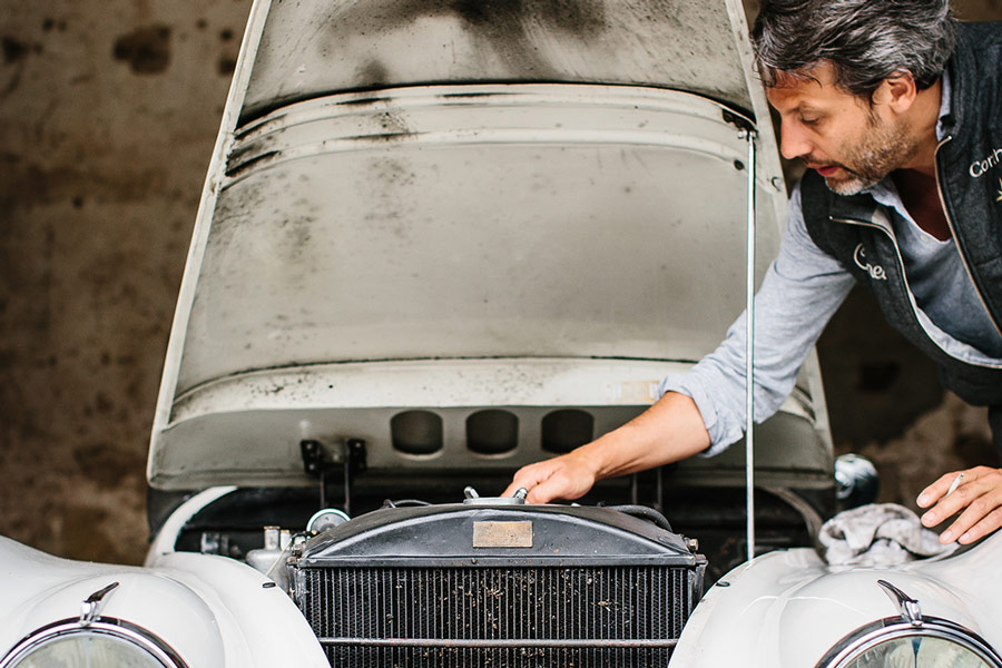 Francois Pourcher tends to his Jaguar XK-120.