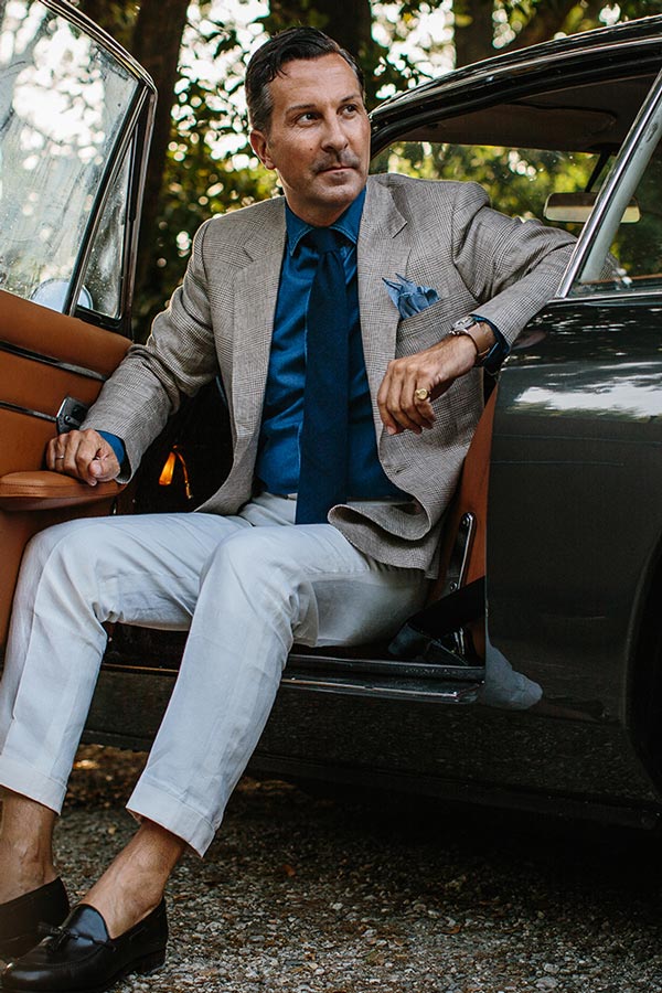 Alexander Kraft wearing Huntsman's brown and white check linen blazer and a pair of Carmina tassel loafers.