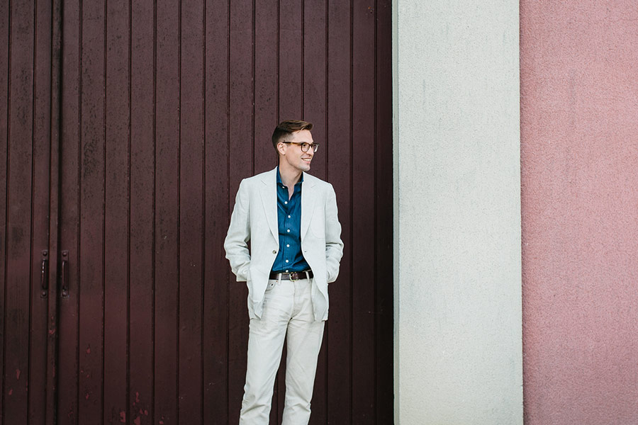 The Rake's Ben St George wears Huntsman's cream linen herringbone blazer and Drake's raw indigo-dyed denim cutaway collar shirt.