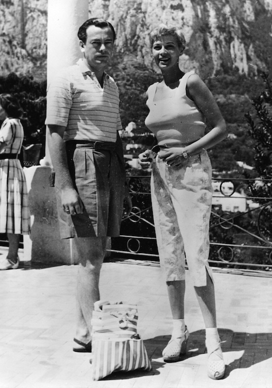 David Mountbatten, 3rd Marquess of Milford Haven wearing wide-legged, pleated shorts with Eva Bartok, 1953.