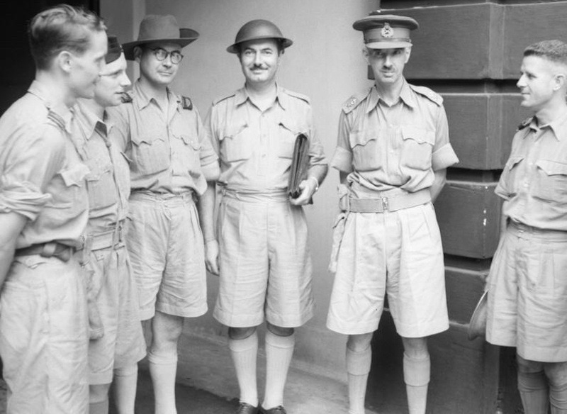 British soldiers stationed in Malaya, wearing high-waisted, Gurkha-style shorts as part of their lightweight Khaki Drill uniforms in 1942.