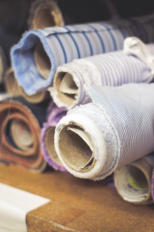 Bolts of colourful cloth carefully stored in the Gloucester factory. Photo by Justin Hast.