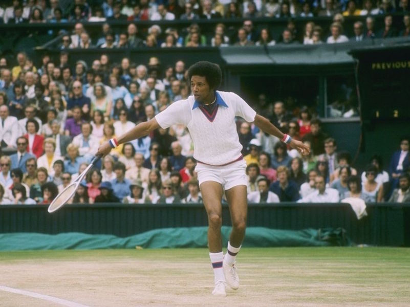 Arthur Ashe's pointed blue collar, thick coloured stripes and chunky wristbands wouldn't comply with Wimbledon's regulations today.