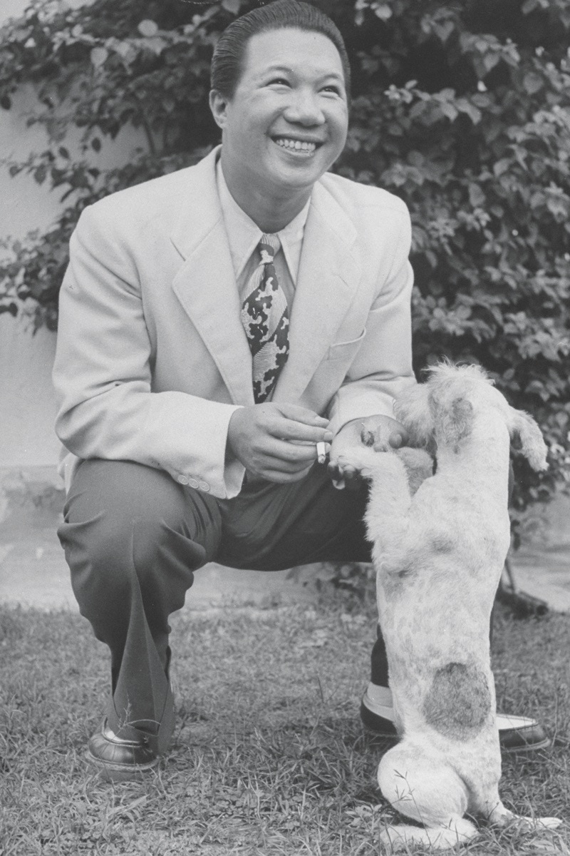 Bao Dai of Annam shaking hands with dog.  (Photo by Jack Birns/The LIFE Picture Collection/Getty Images)