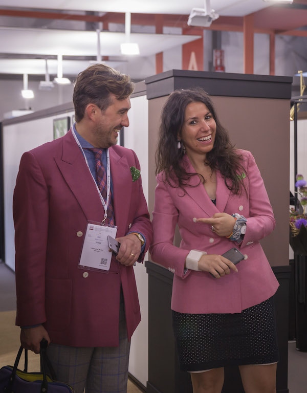 Chris Modoo attending Milano Unica 2017, wearing a raspberry VBC double-breasted jacket and accompanied by Valentina Berti of VBC.