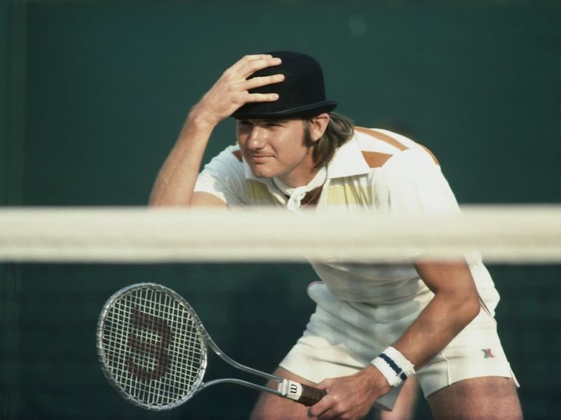 Jimmy Connors wearing a bowler hat during a Men's Doubles match at Wimbledon, 1976.