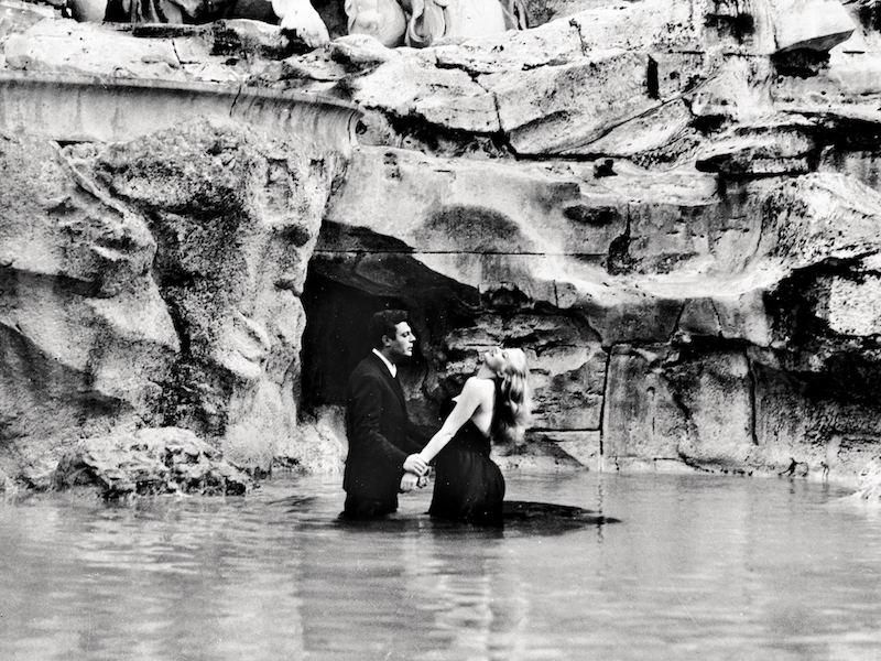 The iconic scene in the Trevi Fountain between Marcello Mastroianni and Anita Ekberg's characters. Photo by Roger Viollet Collection/Getty Images.