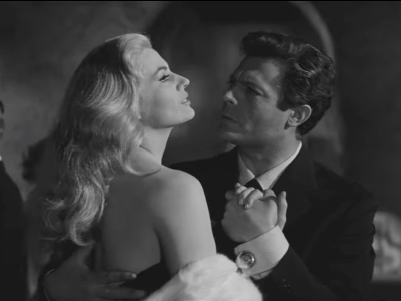 Large, circular polished cufflinks threaten to steal Ekberg's thunder in La Dolce Vita's dancing scene.