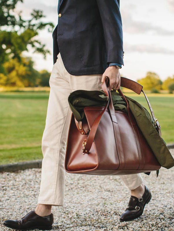 Blazer, Sciamat; cordovan monk straps, Carmina; jacket, Grenfell; leather travel duffle, Frank Clegg. All available on TheRake.com. Photo by Jamie Ferguson.