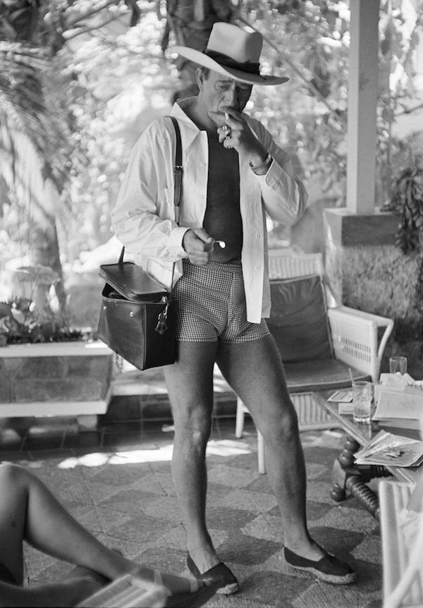 John Wayne in Acapulco wearing suspiciously tight shorts and espadrilles, 1959.