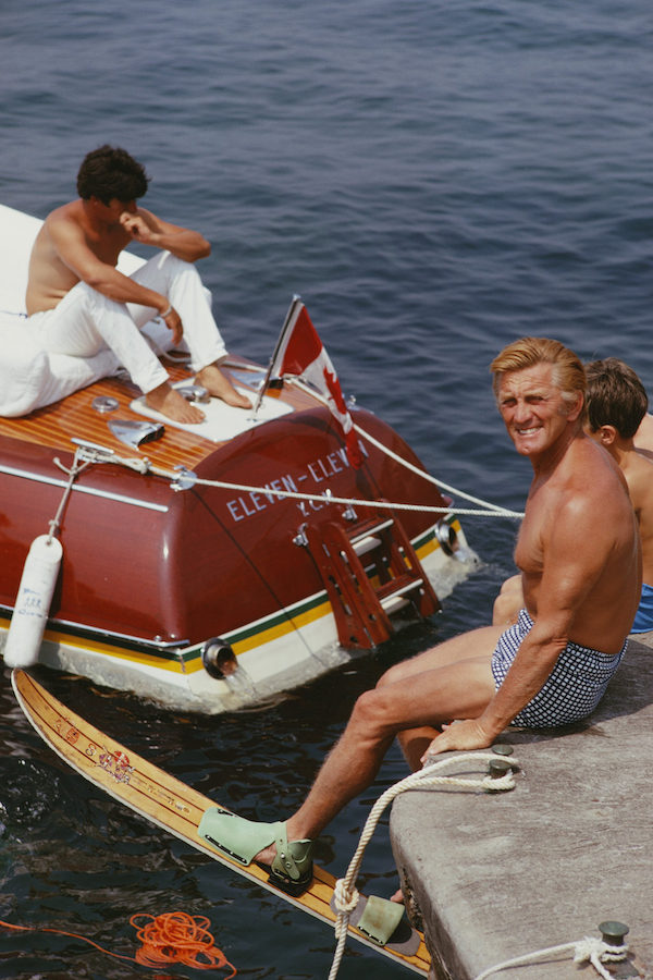 Kirk Douglas prepares to go water-skiing by the hotel in 1969. Photo by Slim Aarons.