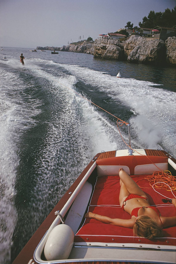 A water-skier and a sunbather enjoying the seas opposite the hotel, circa late 1960s. Photo by Slim Aarons.