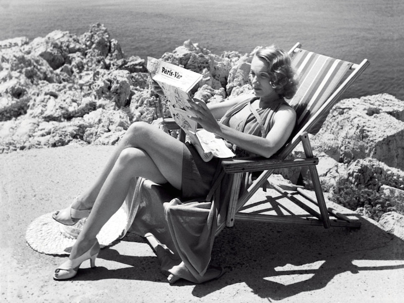 Marlene Dietrich reading on the grounds of the hotel, circa 1940s.