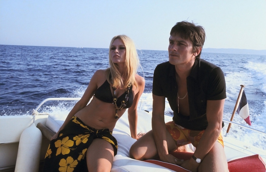 Alain Delon displaying the style credentials of the polo shirt aboard a yacht with Brigitte Bardot, circa 1960s.