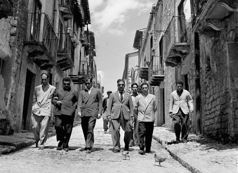 'Lucky' Luciano (third right) walking with his henchmen in Sicily, Italy, 1948. Photo by Slim Aarons/Getty Images.