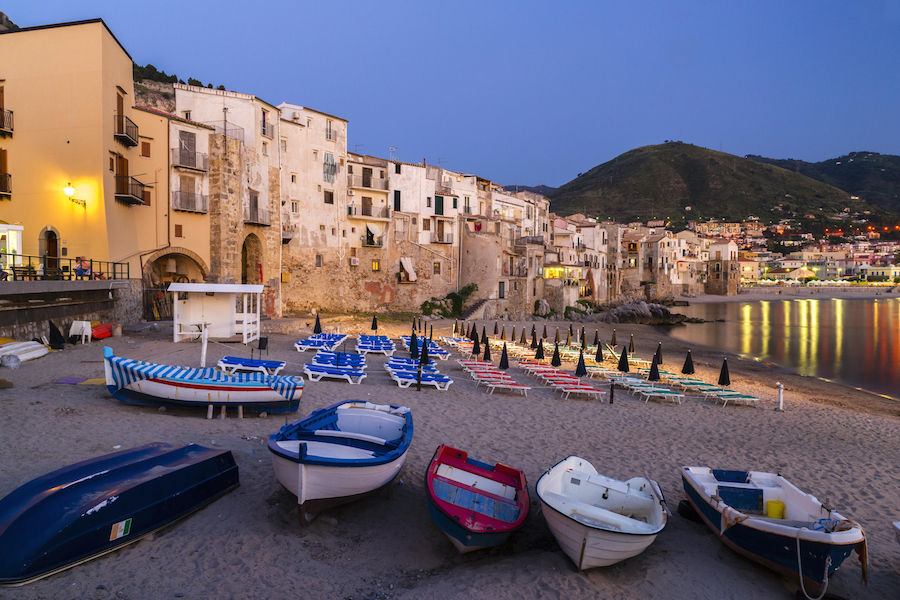 Boats on the beach and harbour in the historic centre of Cefalu, a Province of Palermo, Sicily. Photo by Martin Jung/imageBROKER/REX/Shutterstock.