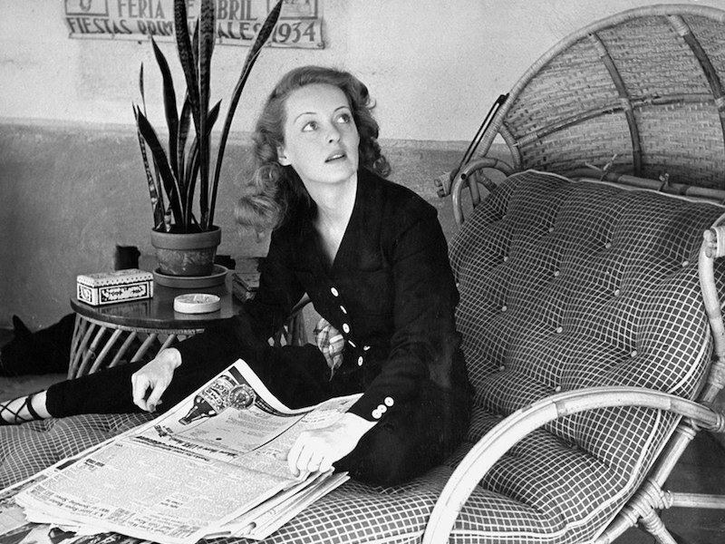 Looking chic whilst skimming the morning papers at home, 1939.