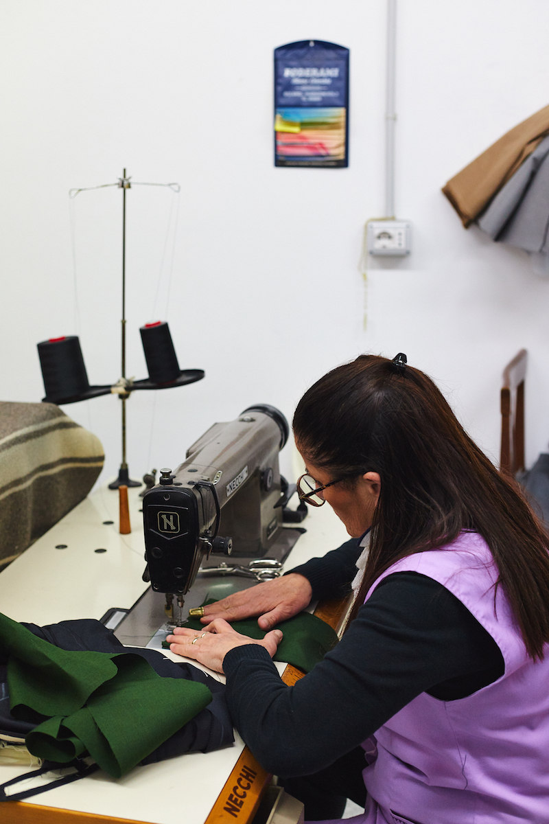 One of Ambrosi's craftspeople closes the exclusive trouser. Photo by James Munro.