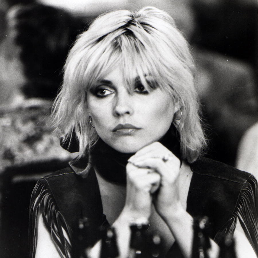 Debbie Harry sits at a dinner in 1970. Photo by GAB Archive/Redferns/Getty Images.