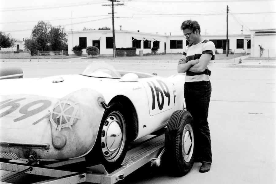 Admiring someone else's Porsche 550 Spyder at a rally, a car that he would shortly after acquire, in 1955. Photo by Collection Christophel/Alamy.