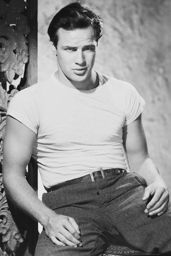 As character Stanley Kowalski in the film A Streetcar Named Desire, 1951. Brando’s T-shirts in the film were unusually tight for the era, displaying more of the male physique than had been seen in mainstream cinema previously.