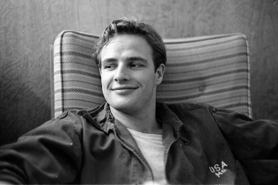 Brando dons an often worn look of his consisting of a plain white T-shirt and US Army overshirt, circa 1955.