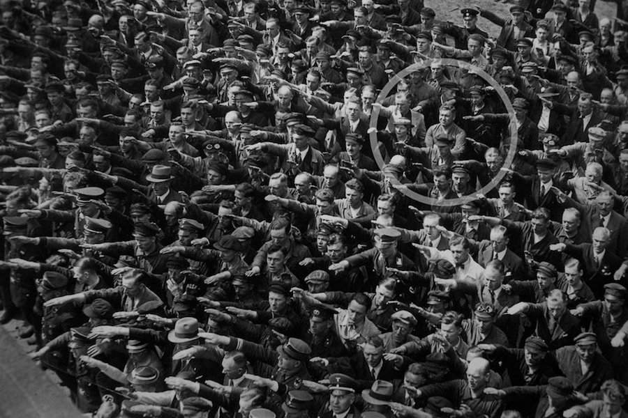 August Landmesser (circled) deliberately crossed his arms instead of saluting, in defiance to Hitler and the Nazi regime, 1936.