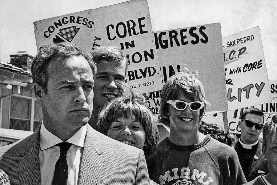 Marlon Brando marches with Congress of Racial Equality (CORE) pickets at Southwood Riviera Royale in Torrance, 1963.