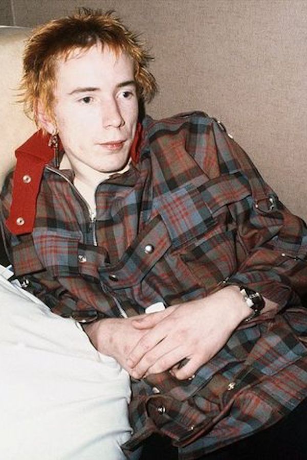 Johnny Rotten wears a Vivienne Westwood tartan coat adorned with metal rings and studs in 1976. Photo by Richard Young.