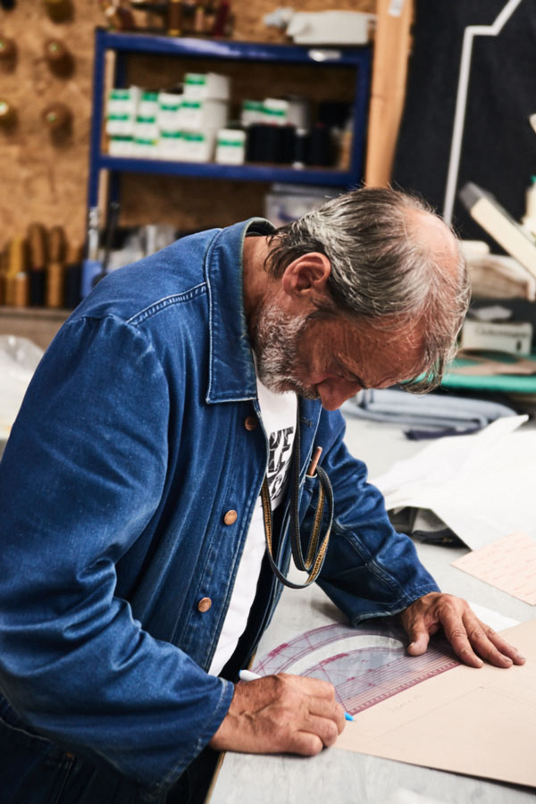 Tracing paper patterns on the cutting table. Photo by Kim Lang.