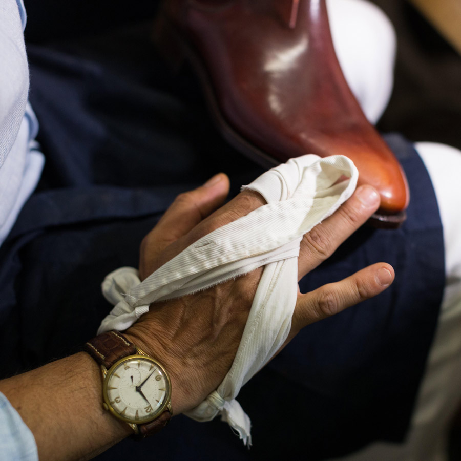 Applying the brand's patina by hand. Photo by Charles-Edouard Woisselin.