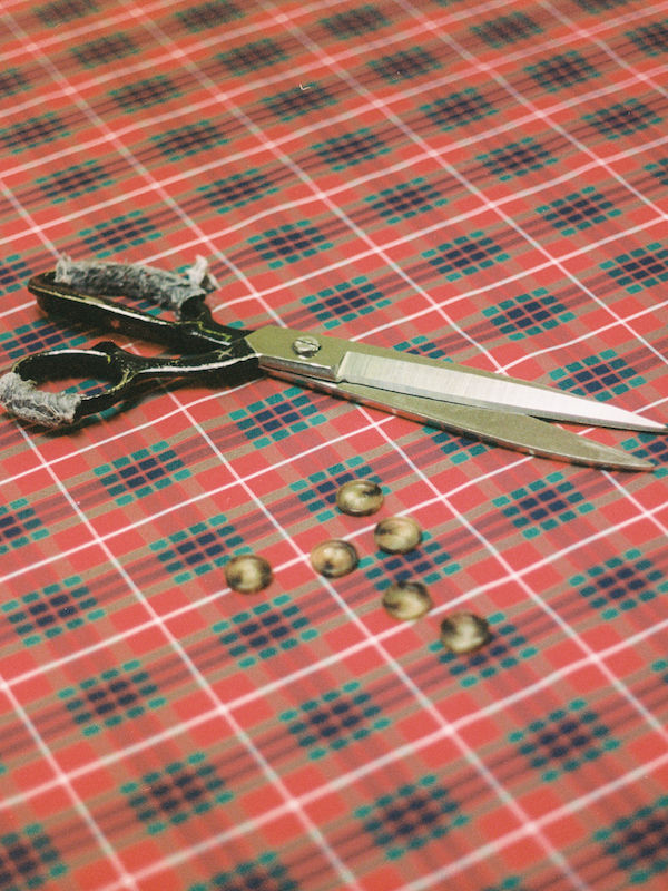 Baracuta's signature tartan fabric on the cutting table.