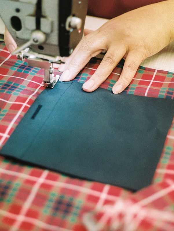 The interior pocket of a G9 being sewn in.