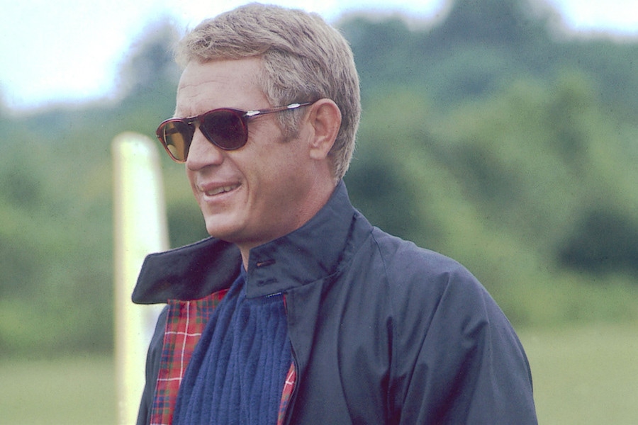 McQueen sporting the classic Harrington jacket in The Thomas Crown Affair, 1968, with a pair of Persol sunglasses.