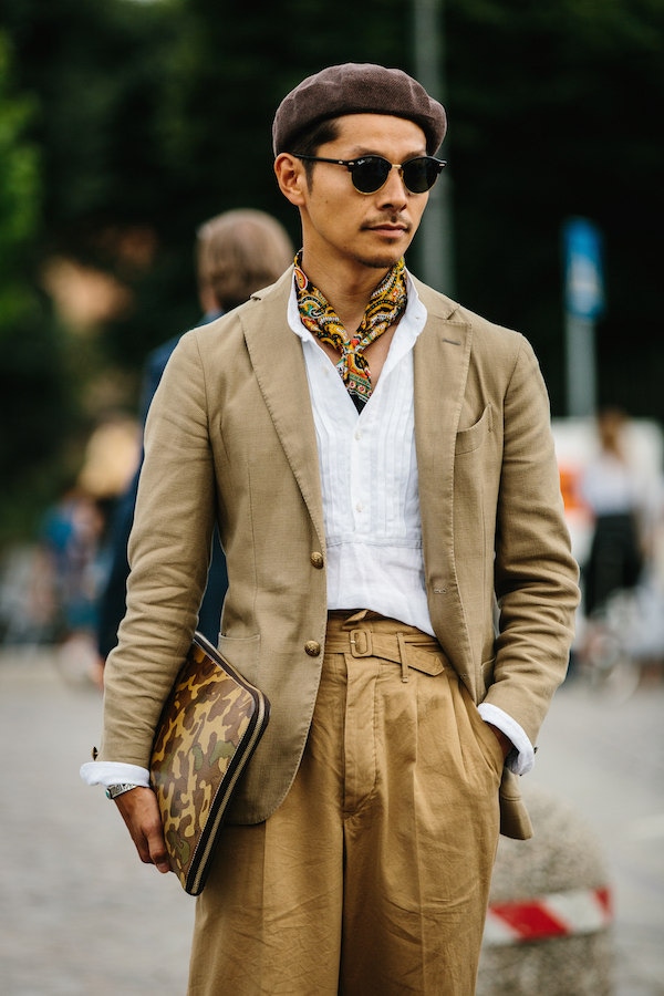 A military-inspired get-up featuring Ghurka-style self-belted, twin-pleated trousers, paisley neckerchief, camouflage portfolio, and jauntily-angled beret. Photo by Jamie Ferguson.