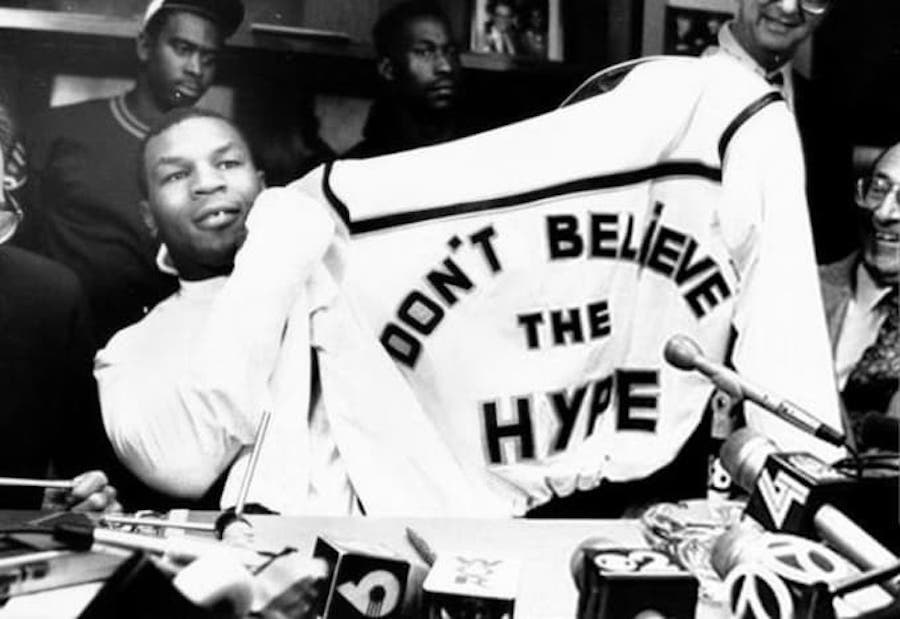 Heavyweight boxing legend Mike Tyson holds up his Don't Believe The Hype jacket at a press conference, 1988.