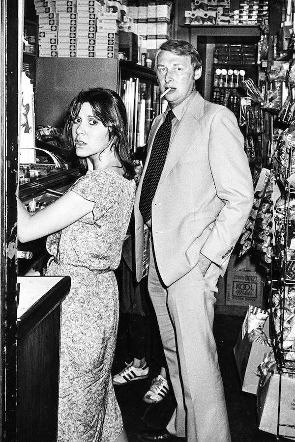 Actress Carrie Fisher and Mike Nichols helping themselves to a drink behind the bar at Elaine's, 1978. Photo by Ron Galella.