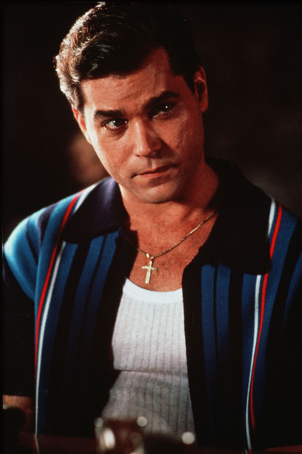 A more casual look for Mr Hill, who wears a knitted contrast-collar striped shirt unbuttoned over a white vest and his gold crucifix. Photo by Warner Bros/Kobal/REX/Shutterstock.