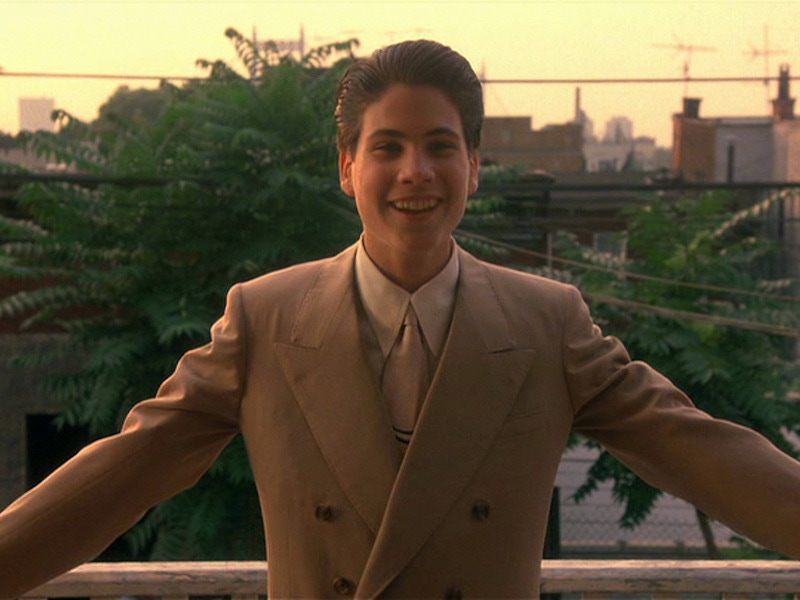 Henry Hill as a young man, played by Christopher Serrone, wears a double-breasted peaked lapel suit, spearpoint collar shirt and pale pink silk tie.