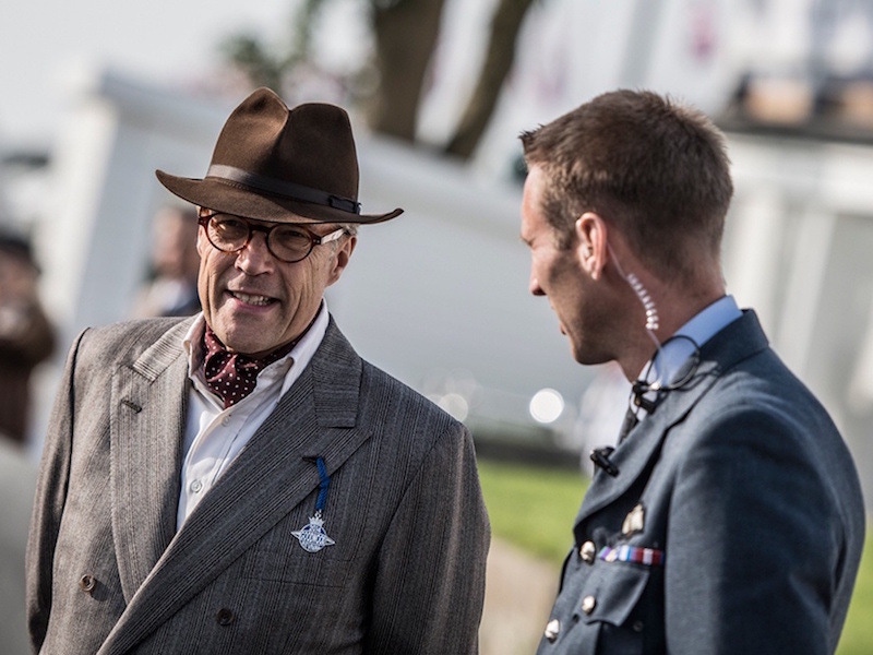 Lord March, owner of Goodwood Estate, wears a 'racing felt' and a double-breasted grey jacket with a silk maroon cravat at Goodwood Revival, 2016.