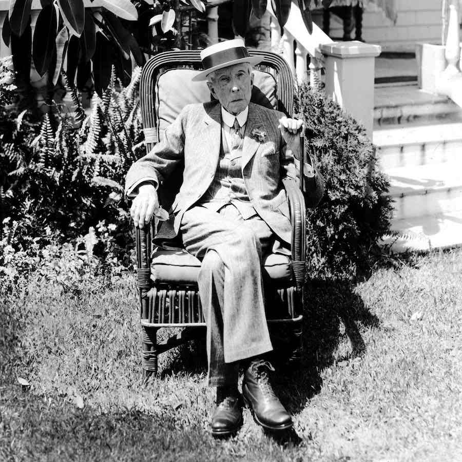 John D. Rockefeller Sr. pictured at his Pocantico Hills home in a three piece suit and boater, circa 1928. Photograph by CSU Archives / Everett Collection.