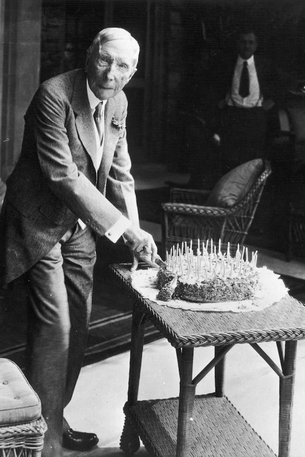 At his home in Pocantico Hills cutting a cake on his 90th birthday, 1929.